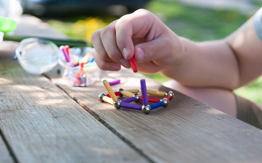 Close-up of someone playing with magnetic toys